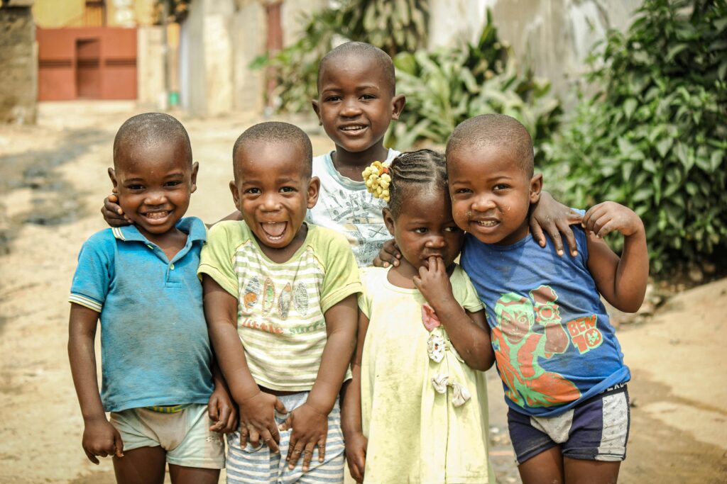 Group of happy children enjoying playtime outdoors in Luanda.